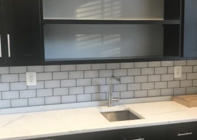 black cabinets with subway tiles